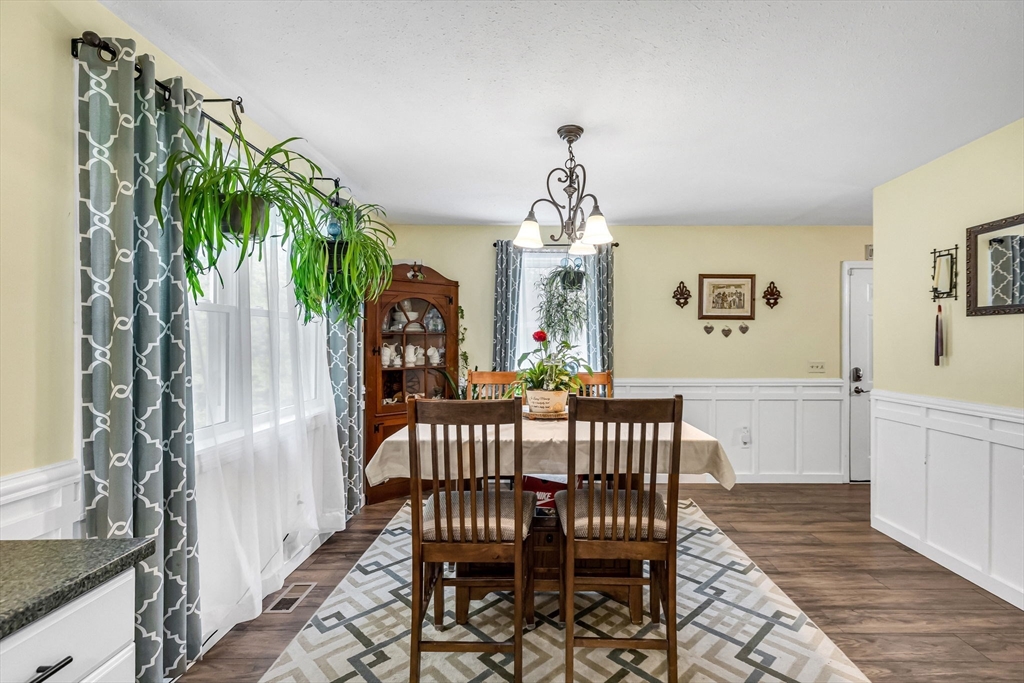 302 Middlefield Road Chester, MA 01011 - Photo 12 of 42 a view of a dining room with furniture and chandelier