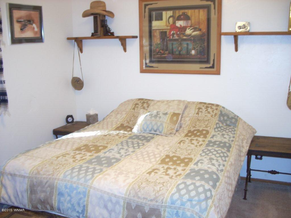 2963 Hunters Road Overgaard, AZ 85933 - Photo 11 of 19 a bedroom with a bed and wall painting