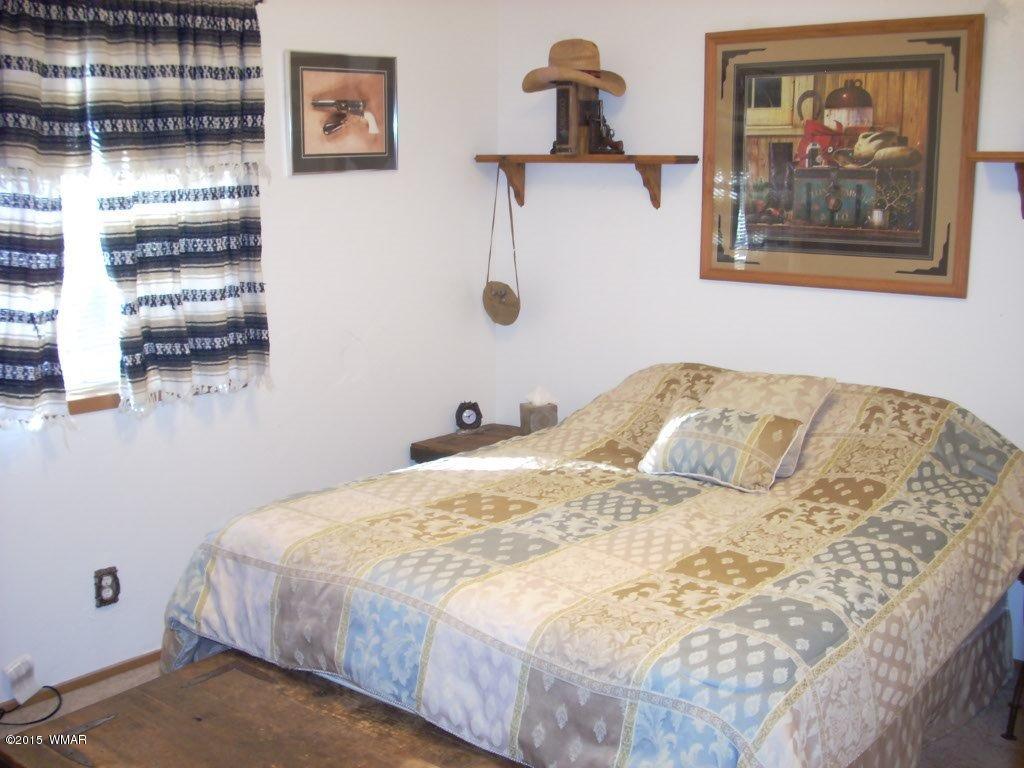 2963 Hunters Road Overgaard, AZ 85933 - Photo 12 of 19 a bedroom with a bed and wall painting