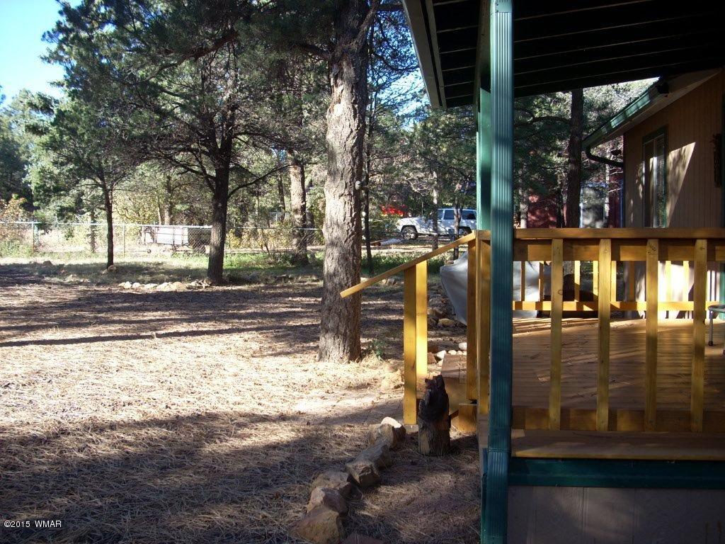 2963 Hunters Road Overgaard, AZ 85933 - Photo 5 of 19 a view of a building with a yard