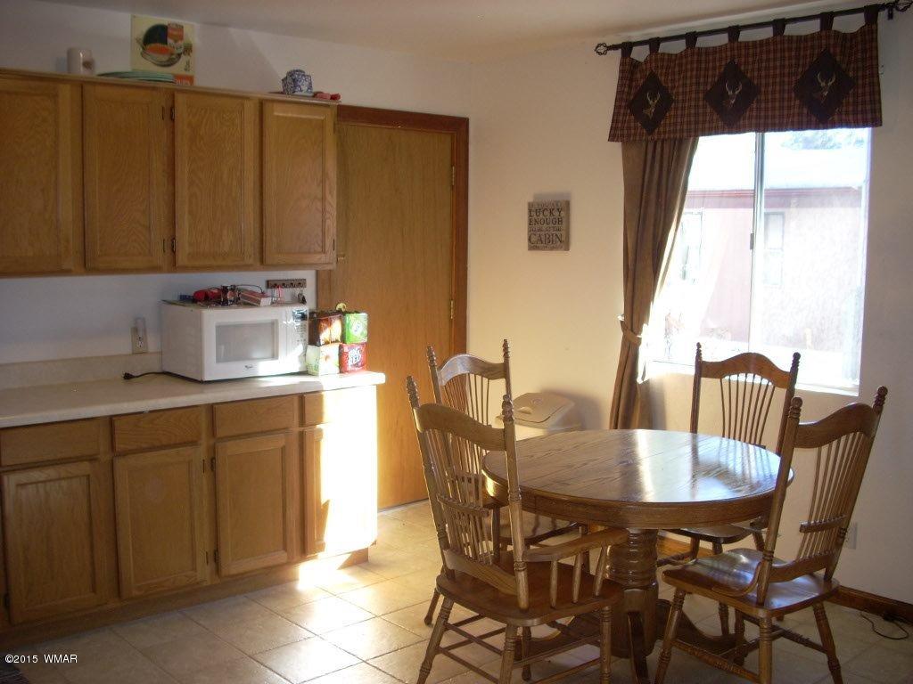 2963 Hunters Road Overgaard, AZ 85933 - Photo 6 of 19 a kitchen with a table chairs and a sink