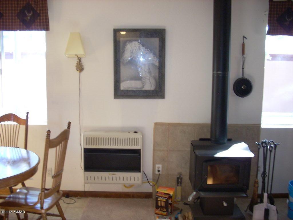 2963 Hunters Road Overgaard, AZ 85933 - Photo 7 of 19 a living room with furniture and a lamp