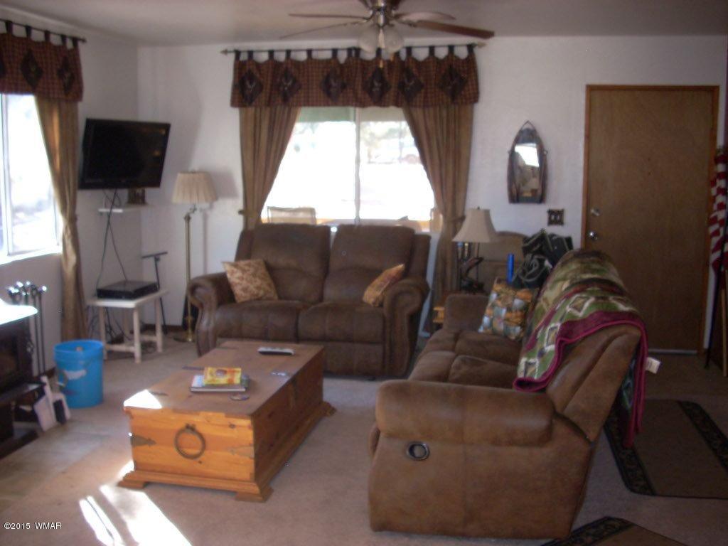 2963 Hunters Road Overgaard, AZ 85933 - Photo 8 of 19 a living room with furniture a flat screen tv and a window