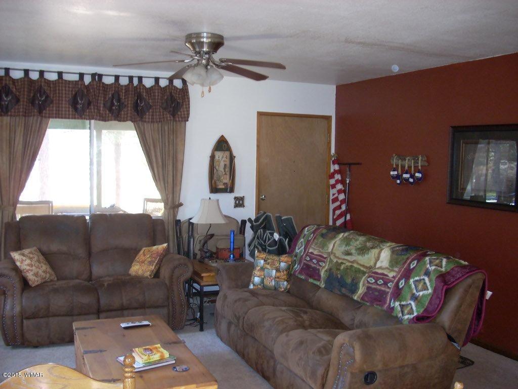 2963 Hunters Road Overgaard, AZ 85933 - Photo 9 of 19 a living room with furniture and a large window