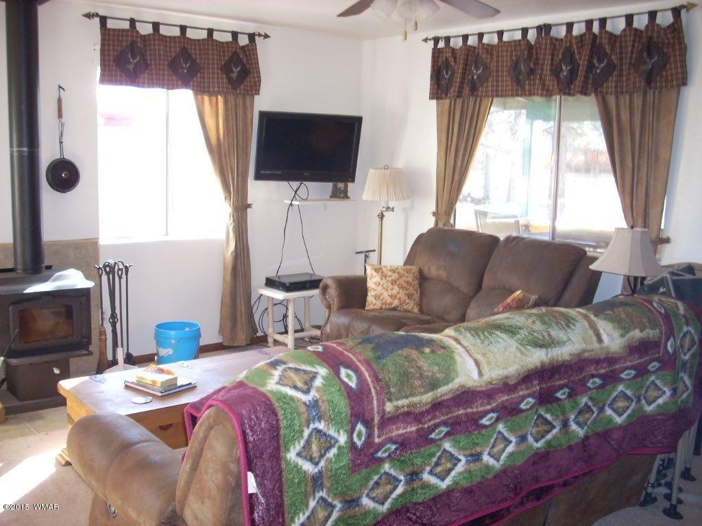 2963 Hunters Road Overgaard, AZ 85933 - Photo 10 of 19 a bedroom with a bed and a flat screen tv