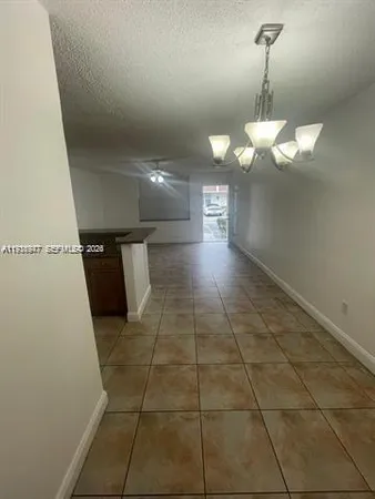 a view of a hallway with a chandelier
