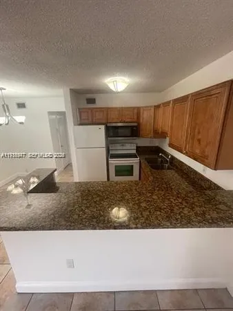 a kitchen with a refrigerator stove and cabinets