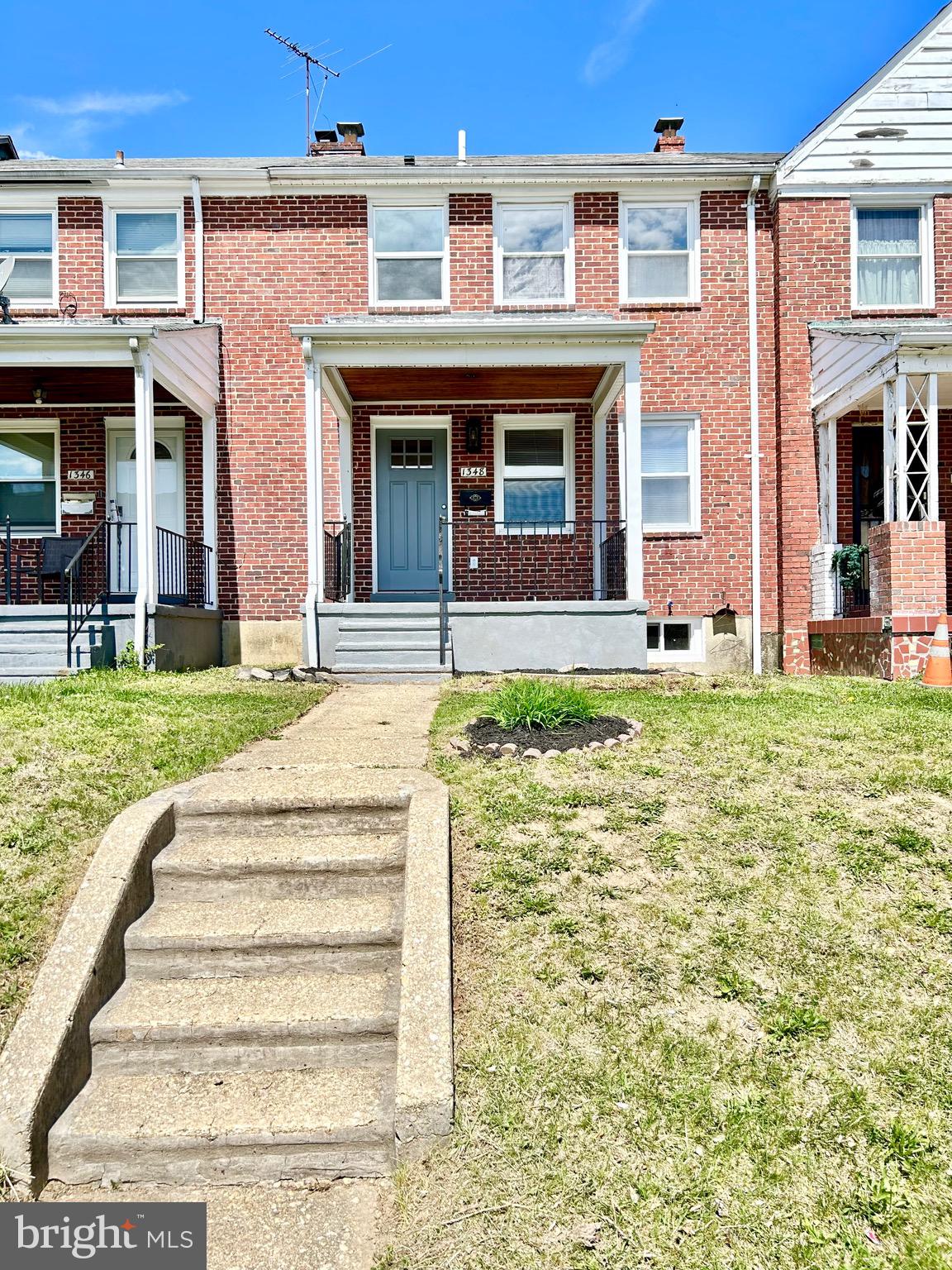 1348 Silverthorne Road Baltimore, MD 21239 - Photo 2 of 25 a front view of a house with a yard