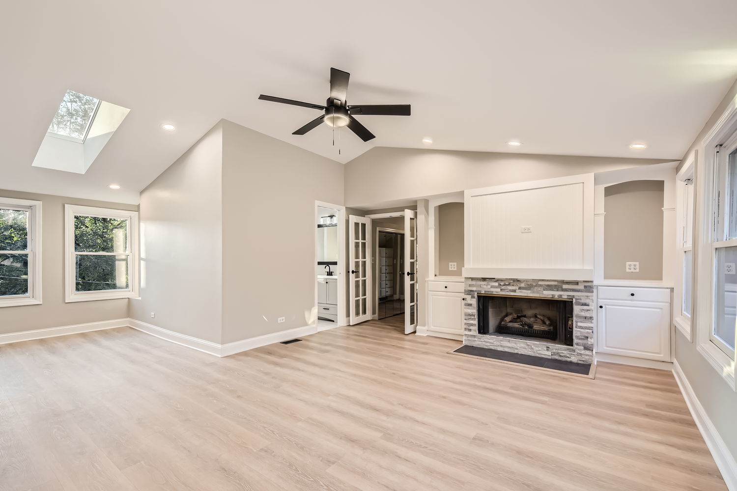 386 Blackhawk Road Riverside, IL 60546 - Photo 21 of 44 an empty room with wooden floor fireplace and window