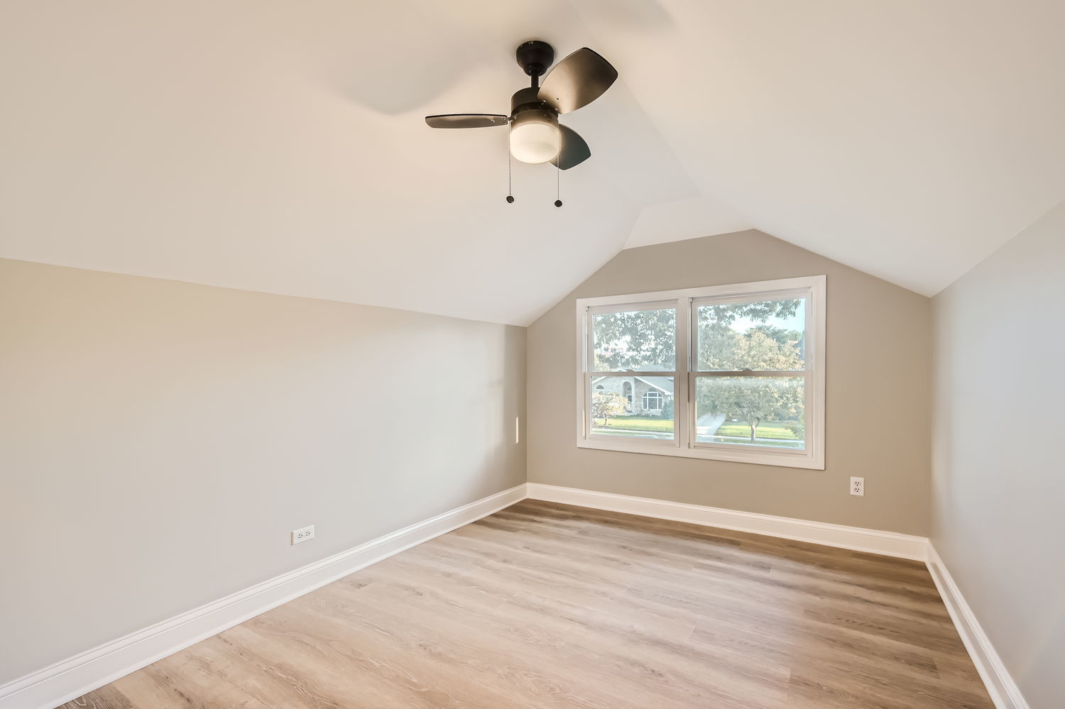 386 Blackhawk Road Riverside, IL 60546 - Photo 23 of 44 an empty room with wooden floor chandelier fan and windows