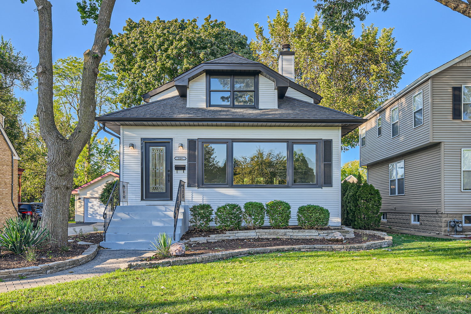 386 Blackhawk Road Riverside, IL 60546 - Photo 4 of 44 a front view of a house with swimming pool having outdoor seating