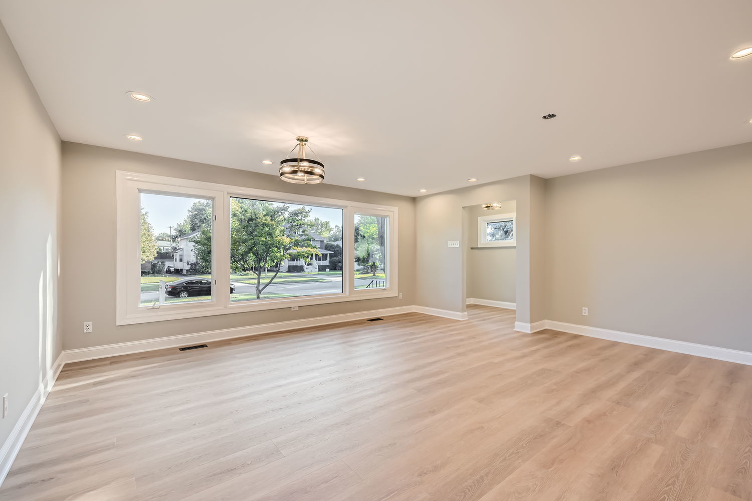 386 Blackhawk Road Riverside, IL 60546 - Photo 6 of 44 an empty room with wooden floor and windows
