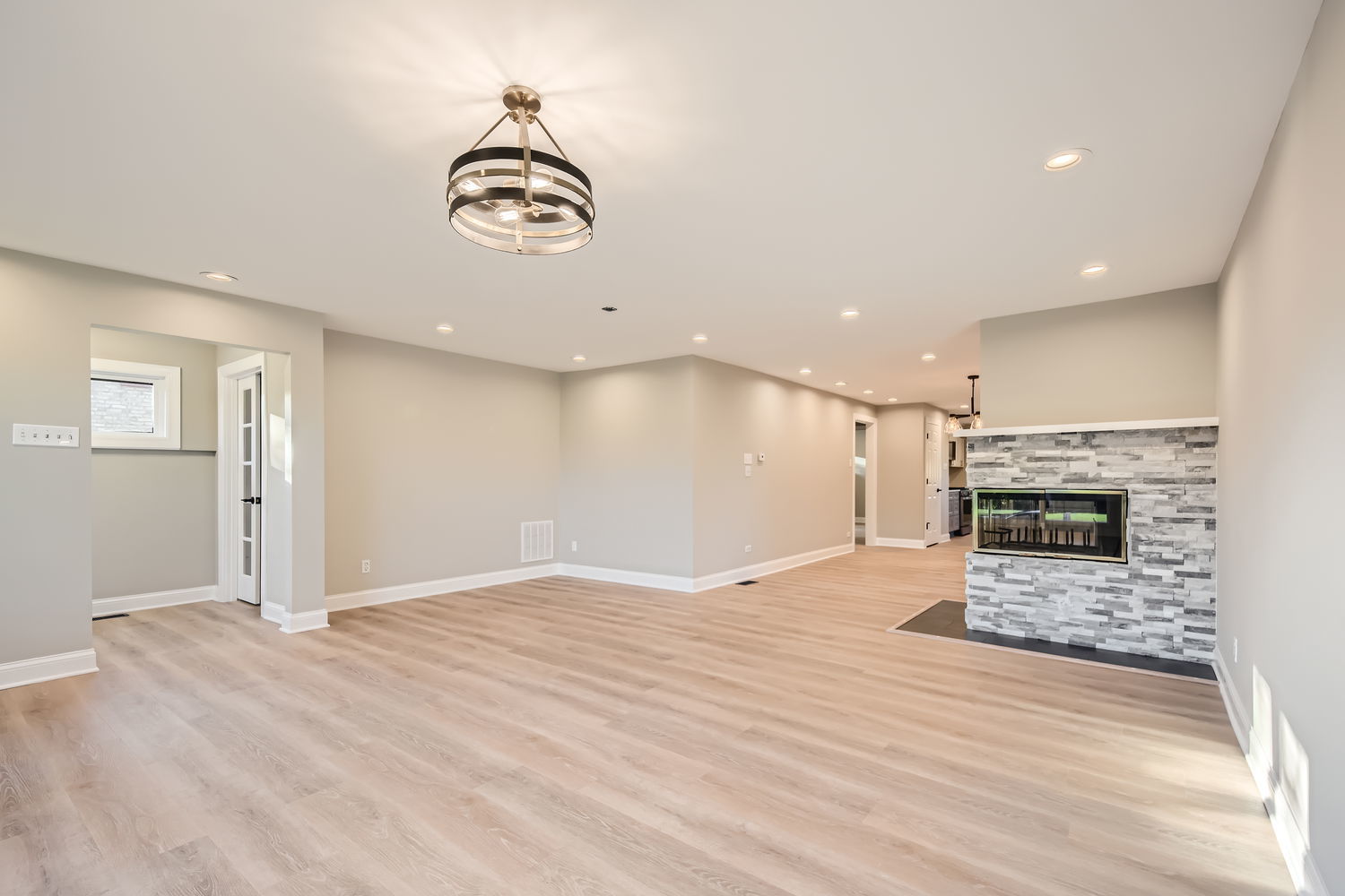 386 Blackhawk Road Riverside, IL 60546 - Photo 7 of 44 an empty room with wooden floor fireplace and window