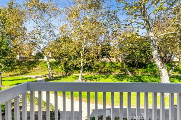 a view of a balcony with wooden fence