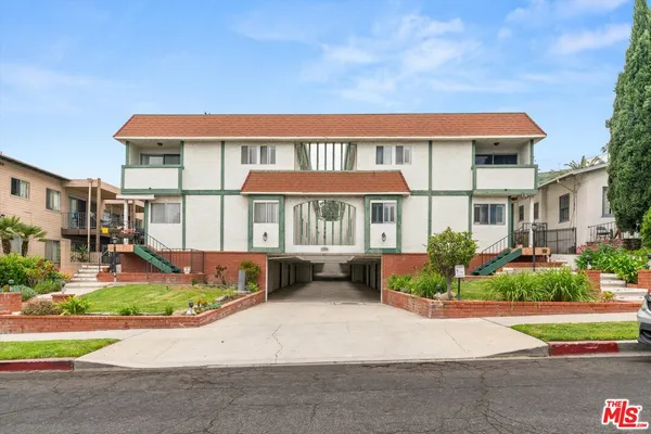 front view of a brick house with a yard