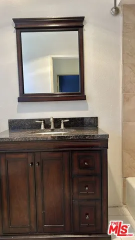 a bathroom with a shower and a bath tub