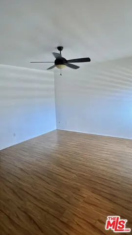 a view of an empty room and wooden floor