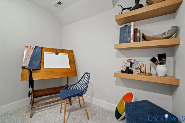 a living room with furniture and a chair