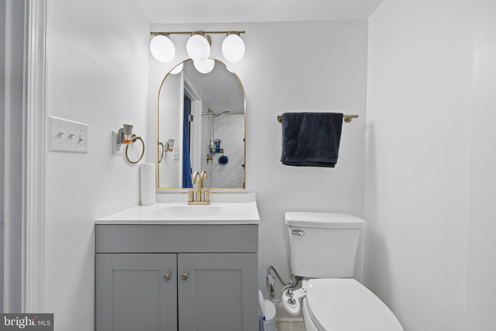 4511 Marble Hall Road Baltimore, MD 21239 - Photo 38 of 48 a bathroom with a toilet sink and mirror
