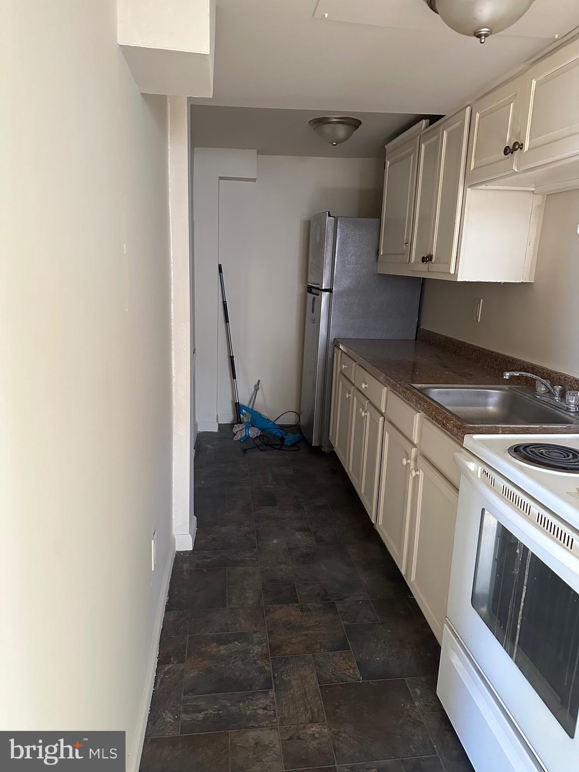615 5th Street, Unit 1 Lancaster, PA 17603 - Photo 4 of 5 a kitchen with granite countertop a sink and a stove