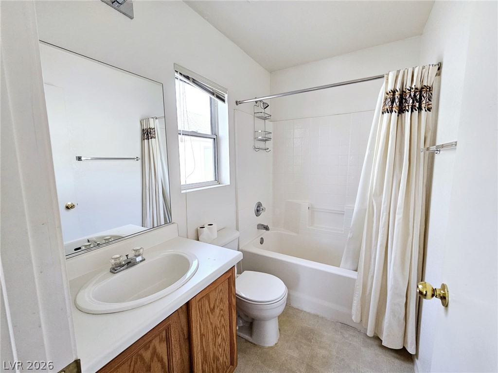1663 Lefty Garcia Way Henderson, NV 89002 - Photo 14 of 31 Bright, white, and well-appointed, this bathroom offers practical comfort and essential fixtures.