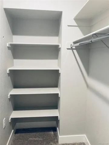 a view of a livingroom with wooden floor a fireplace and windows