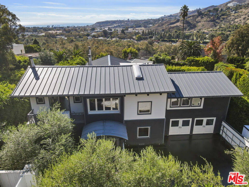 3631 Serra Road Malibu, CA 90265 - Photo 1 of 74 an aerial view of a house with a yard