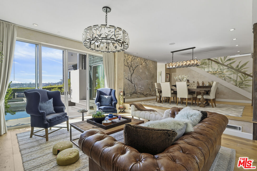 3631 Serra Road Malibu, CA 90265 - Photo 16 of 74 a living room with furniture and a chandelier