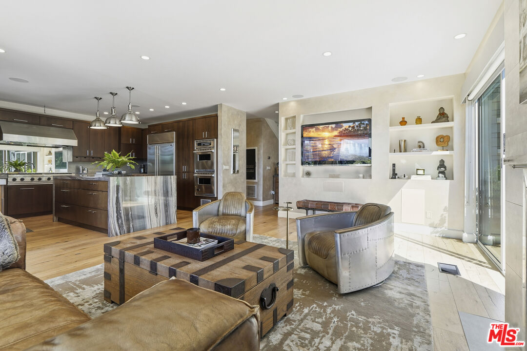 3631 Serra Road Malibu, CA 90265 - Photo 22 of 74 a living room with furniture and flat screen tv