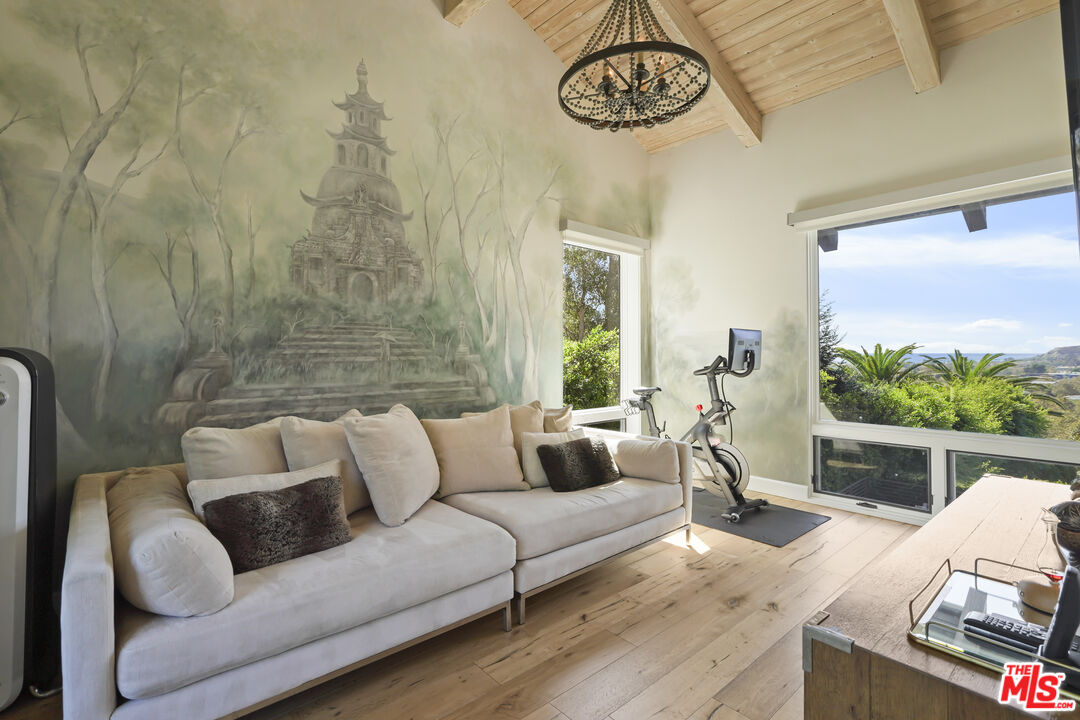 3631 Serra Road Malibu, CA 90265 - Photo 29 of 74 a living room with furniture and a large window