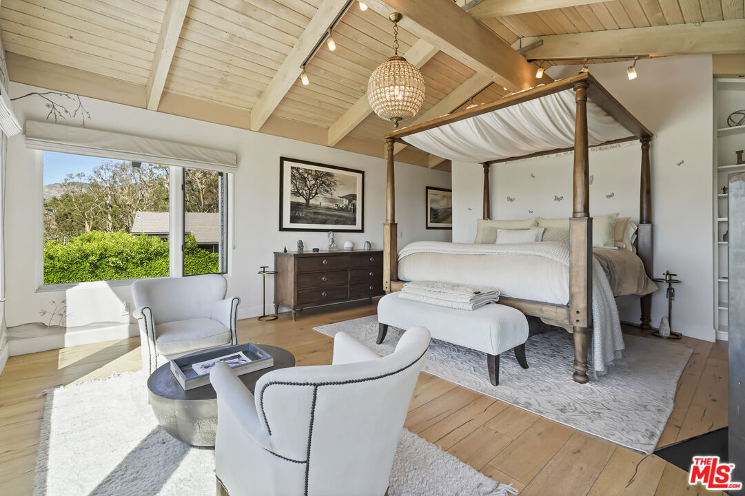 3631 Serra Road Malibu, CA 90265 - Photo 36 of 74 a living room with furniture and a large window