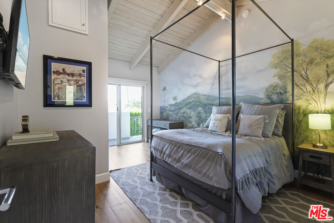 3631 Serra Road Malibu, CA 90265 - Photo 40 of 74 a bedroom with a bed window and a potted plant