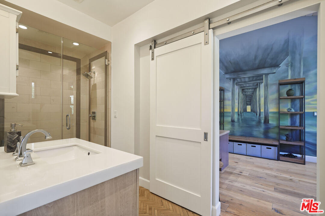 3631 Serra Road Malibu, CA 90265 - Photo 42 of 74 a bathroom with a sink and mirror