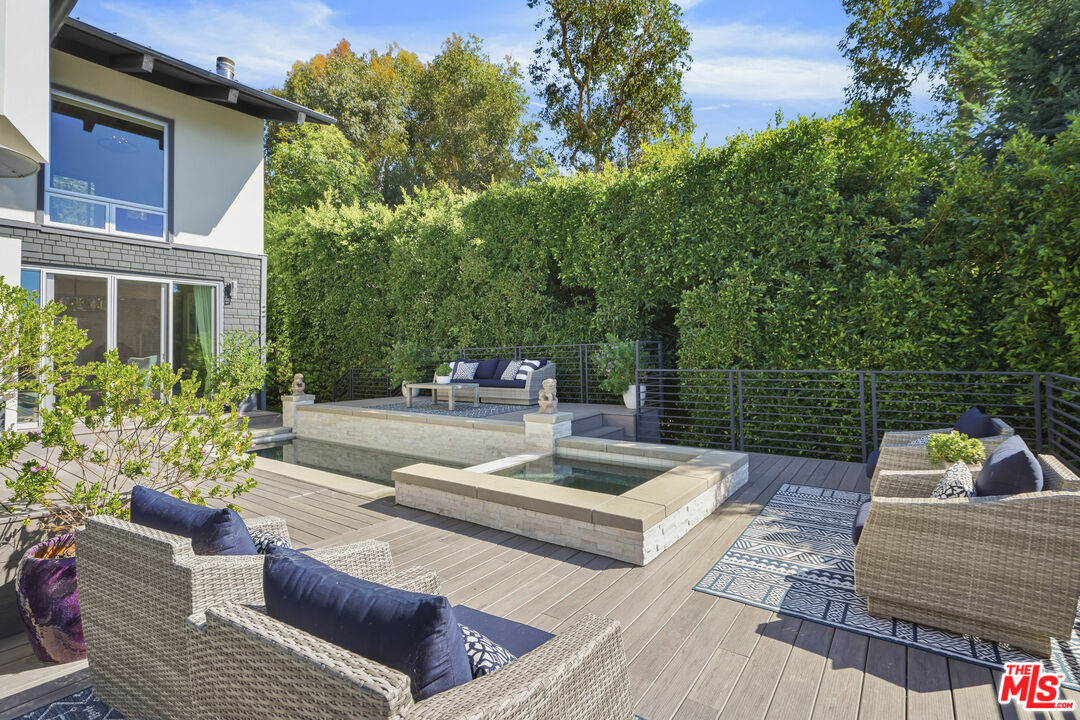 3631 Serra Road Malibu, CA 90265 - Photo 54 of 74 a view of a deck with couches table and chairs and potted plants