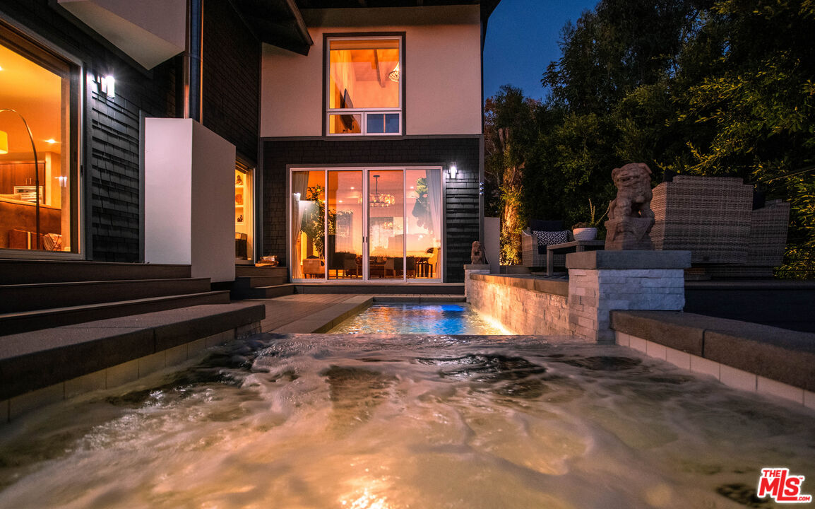 3631 Serra Road Malibu, CA 90265 - Photo 69 of 74 a swimming pool with outdoor seating and yard