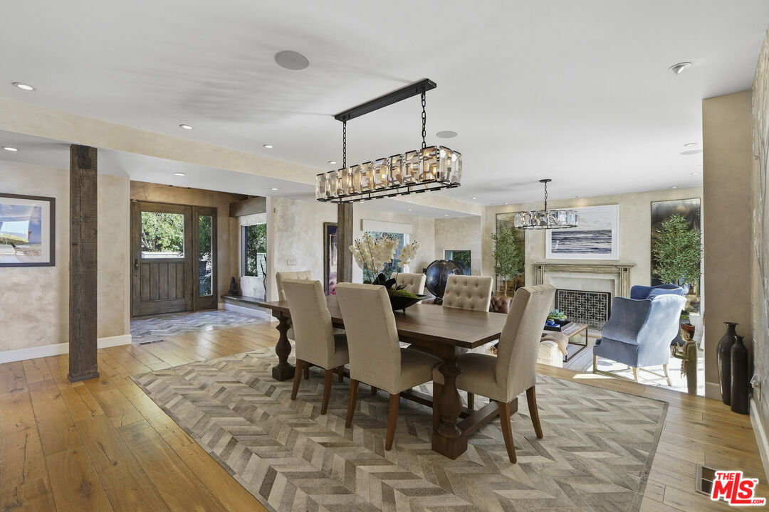 3631 Serra Road Malibu, CA 90265 - Photo 10 of 74 a view of a dining room with furniture window and wooden floor