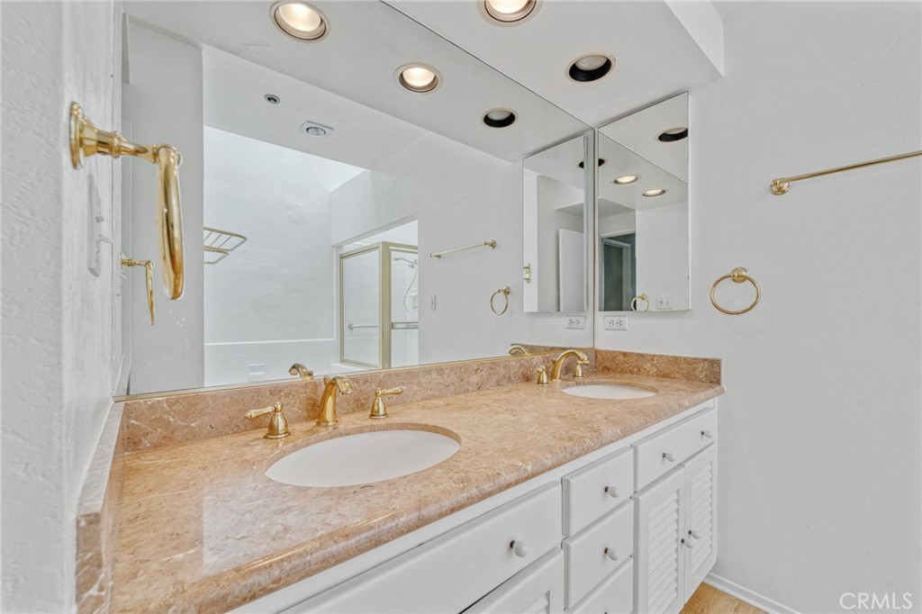 2910 Neilson Way, Unit 503 Santa Monica, CA 90405 - Photo 12 of 27 a bathroom with a granite countertop sink and a mirror