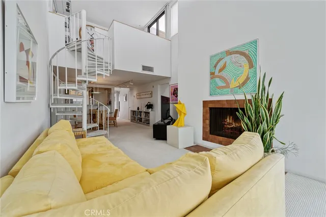 a living room with fireplace furniture and a chandelier