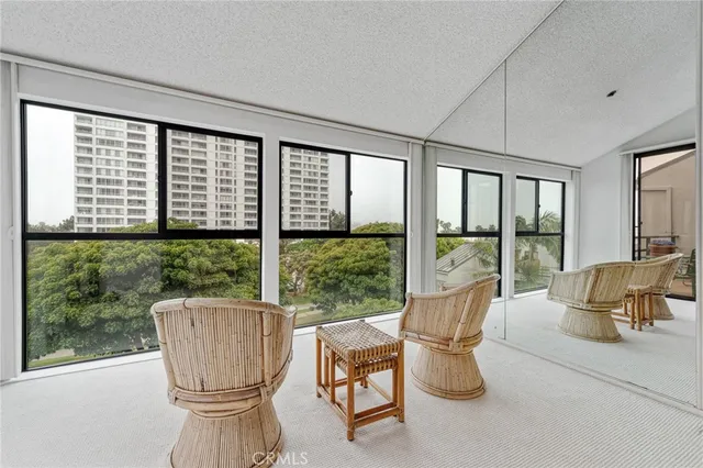 a living room with furniture and a floor to ceiling window