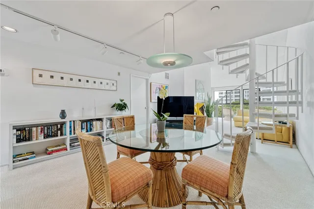 a living room with furniture a flat screen tv and a table