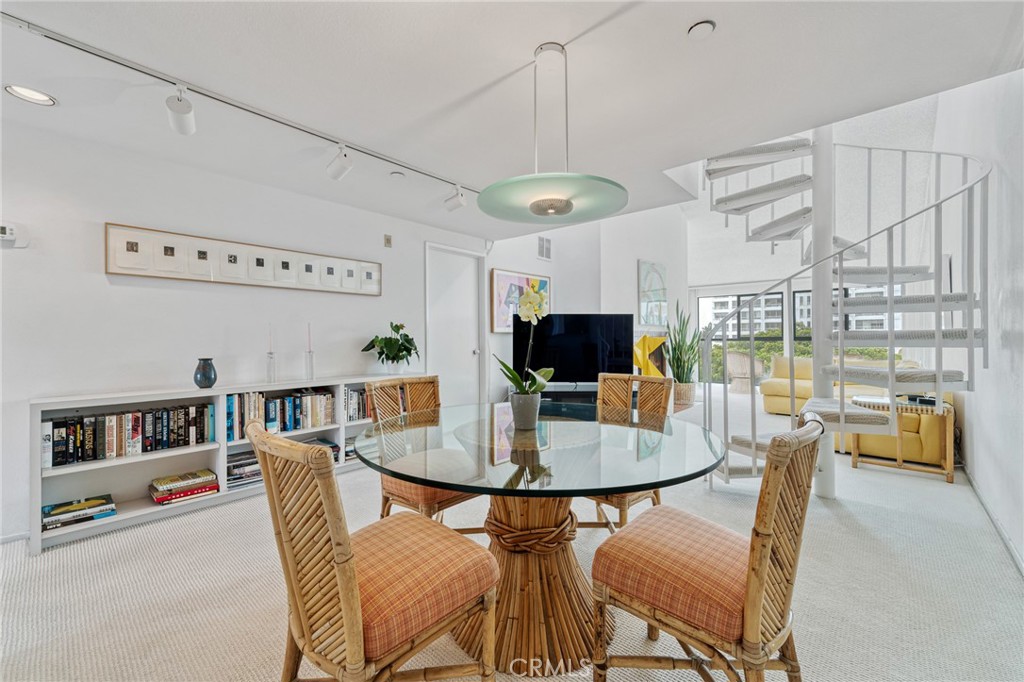 2910 Neilson Way, Unit 503 Santa Monica, CA 90405 - Photo 7 of 27 a dining room with furniture a rug and a flat screen tv