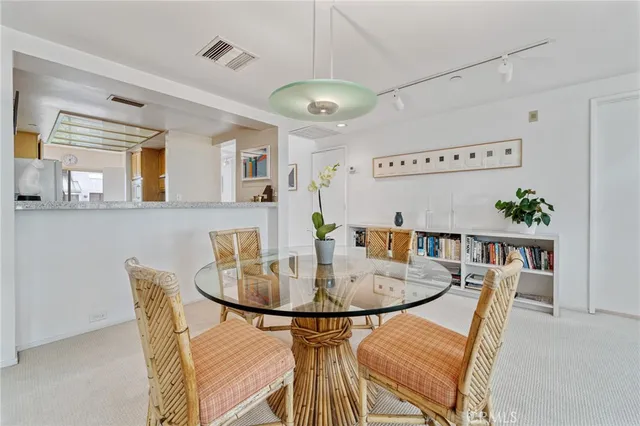 a view of a dining room with furniture and chandelier