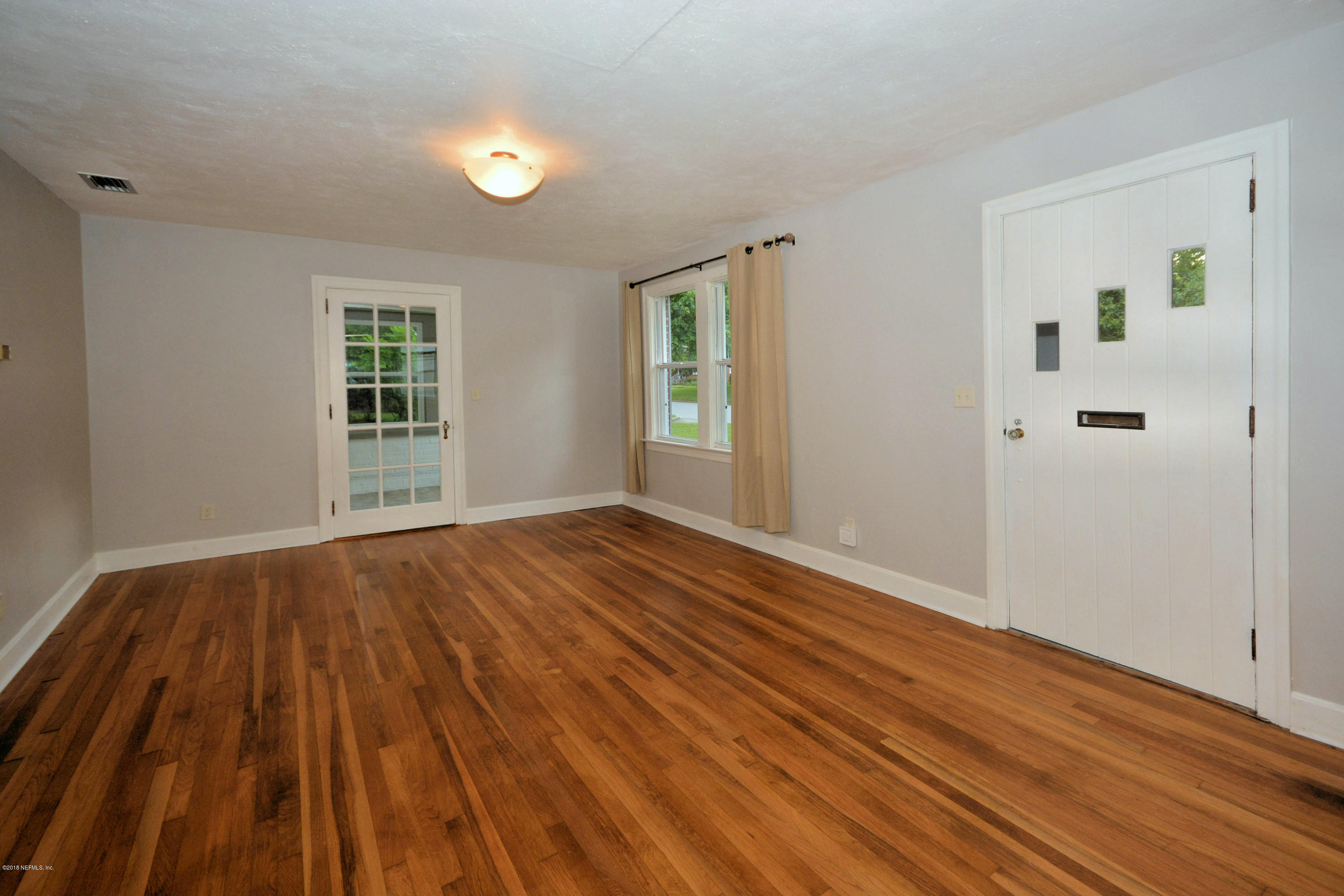 904 Old Hickory Road Jacksonville, FL 32207 - Photo 9 of 24 wooden floor in an empty room with a window