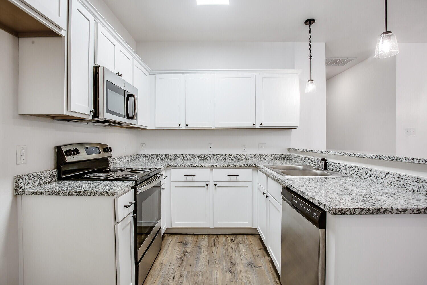 2539 138th Street Lubbock, TX 79423 - Photo 9 of 15 a kitchen with stainless steel appliances granite countertop a sink stove and cabinets