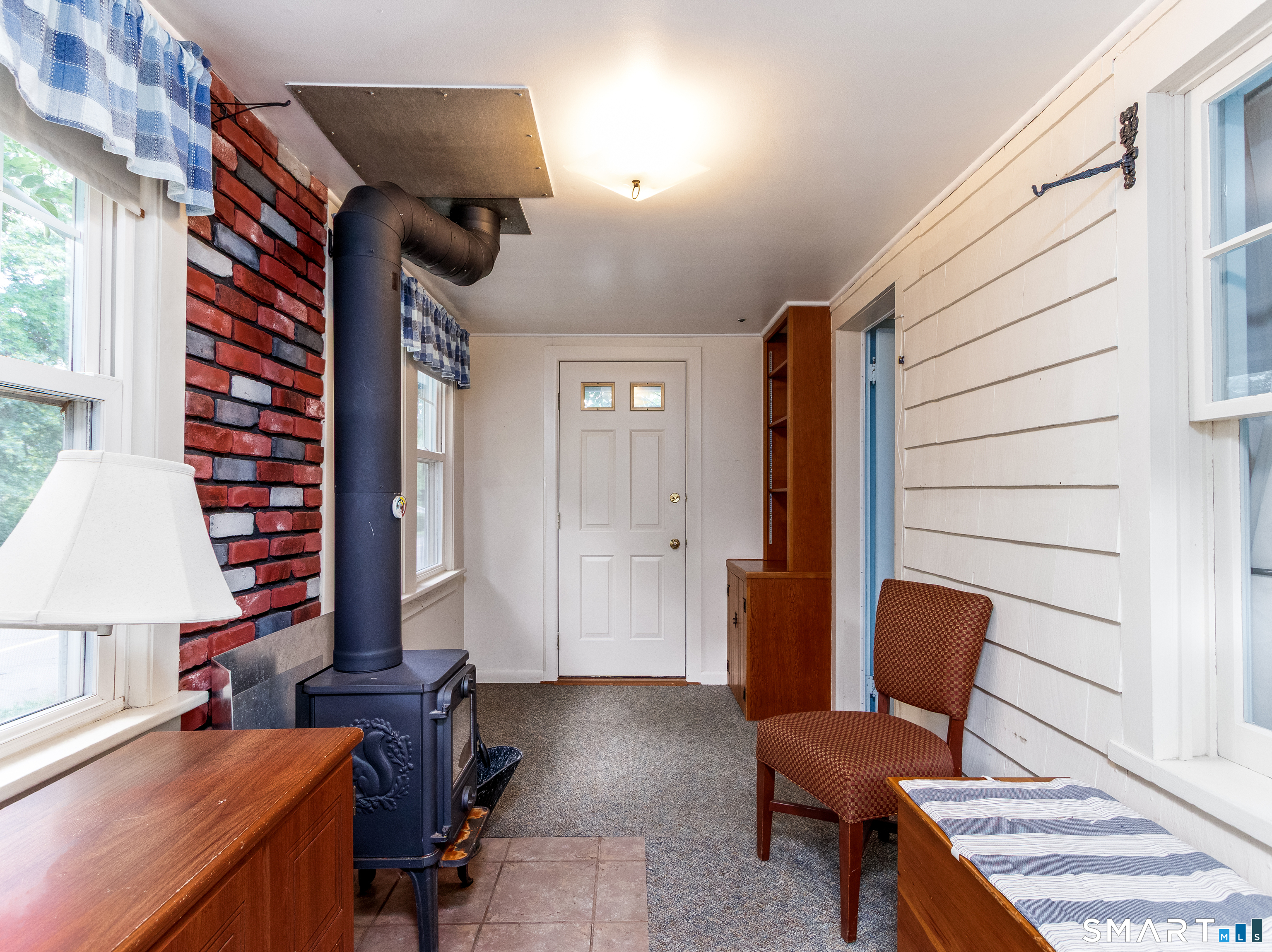 208 Twin Lakes Road North Branford, CT 06471 - Photo 15 of 39 Front Enclosed Porch with Wood Stove