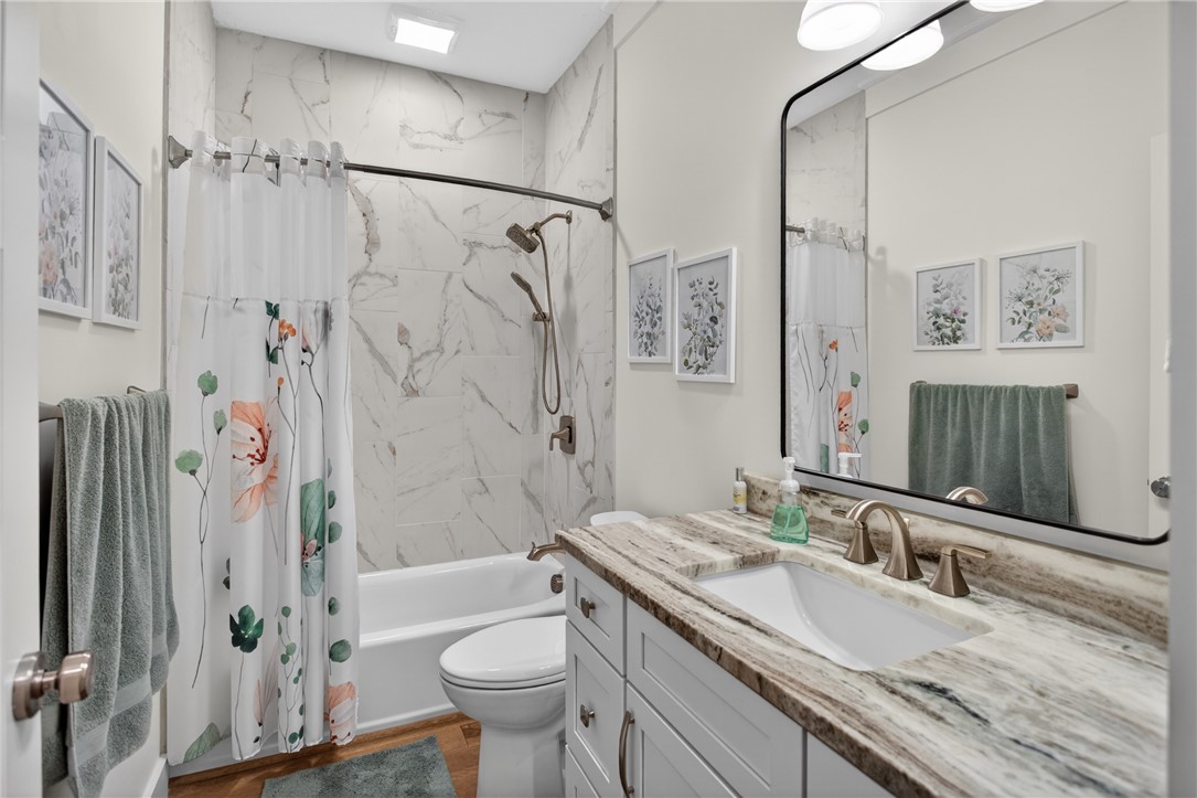 921 Falling Waters Lane Seneca, SC 29672 - Photo 31 of 46 A well-appointed bathroom features a sleek vanity with ample counter space and a modern shower/tub combination.