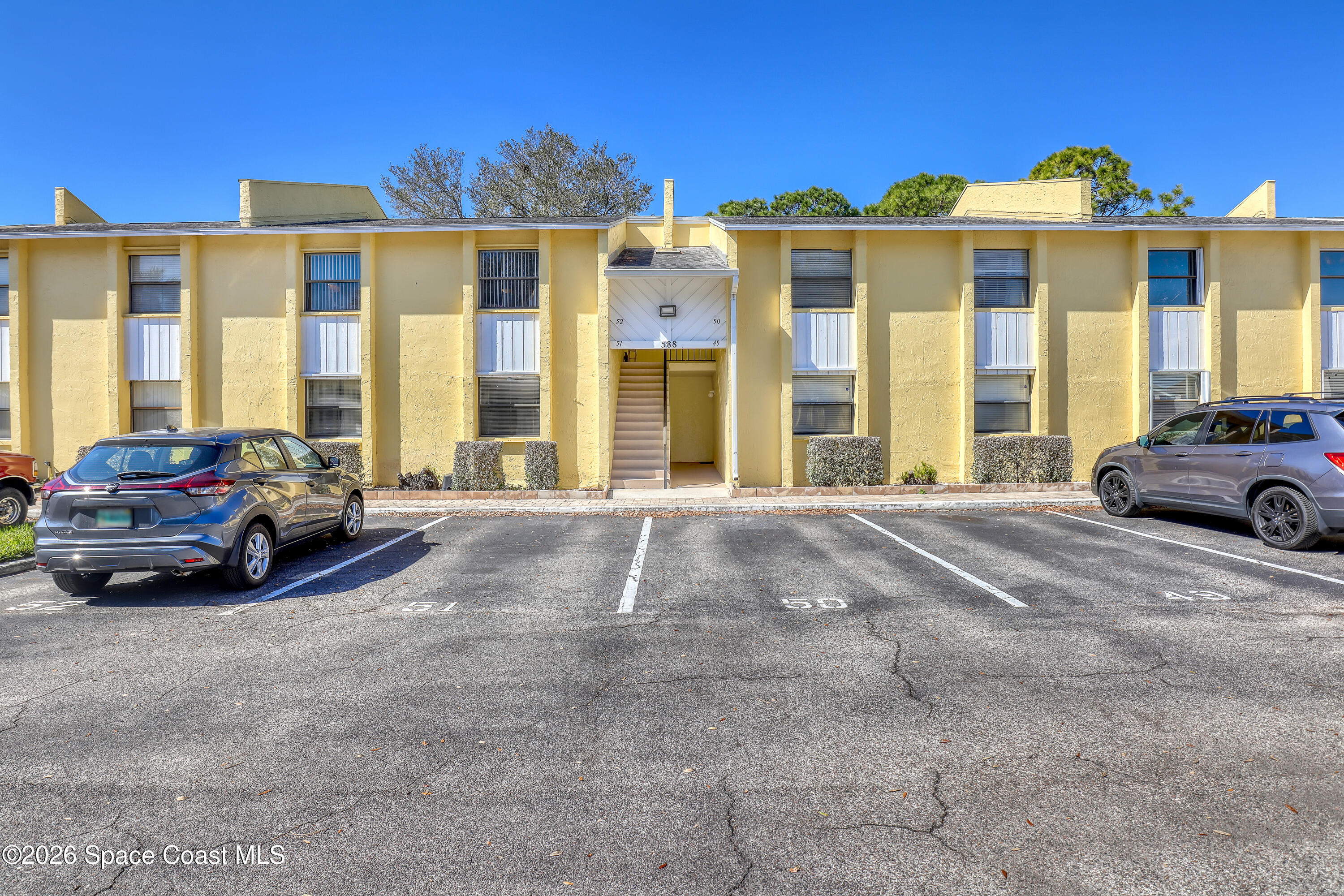 588 North Wickham Road, Unit 51 Melbourne, FL 32935 - Photo 1 of 27 a view of a car parked in front of a house
