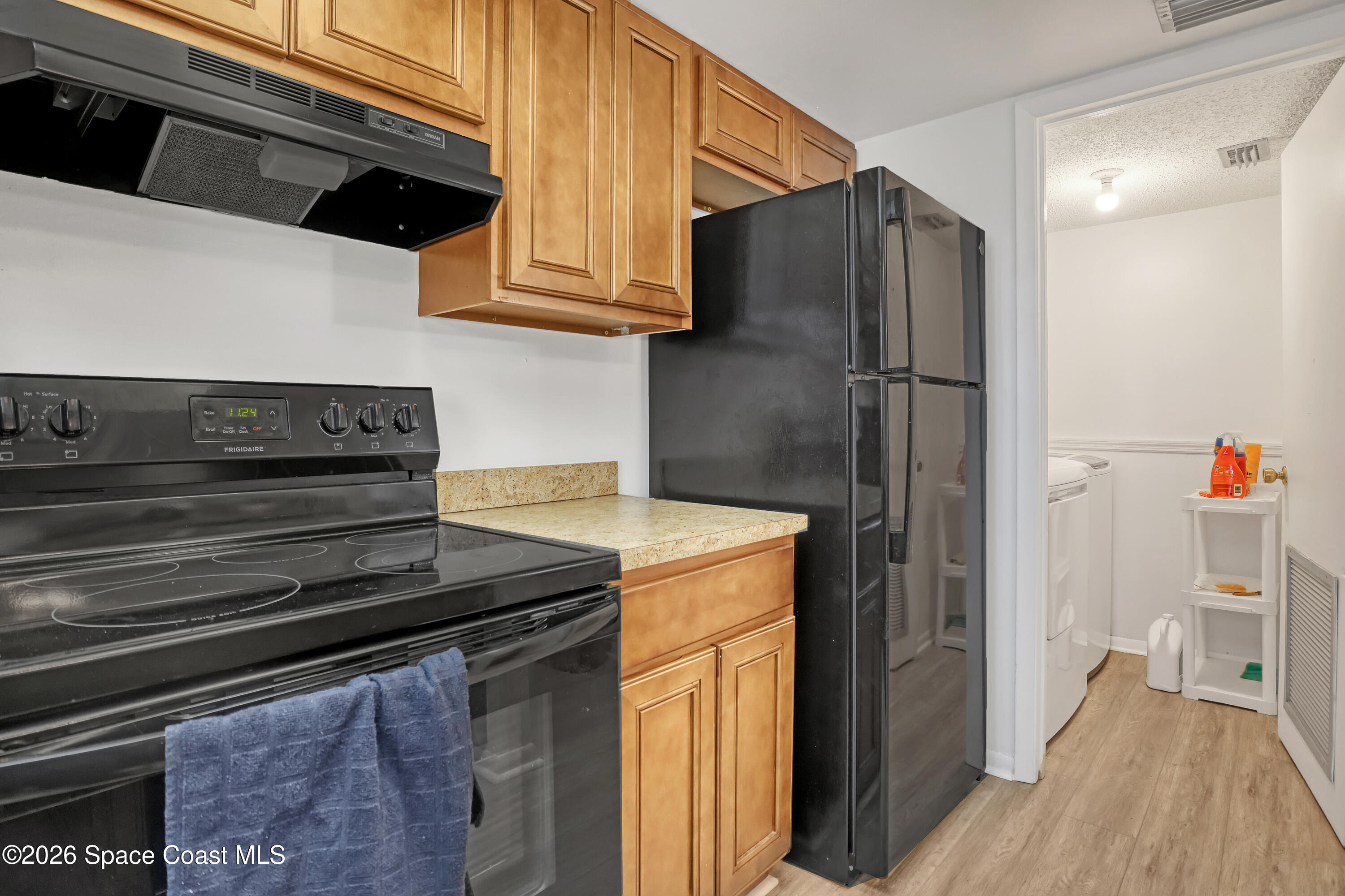 588 North Wickham Road, Unit 51 Melbourne, FL 32935 - Photo 11 of 27 a kitchen with stainless steel appliances granite countertop a refrigerator and a stove