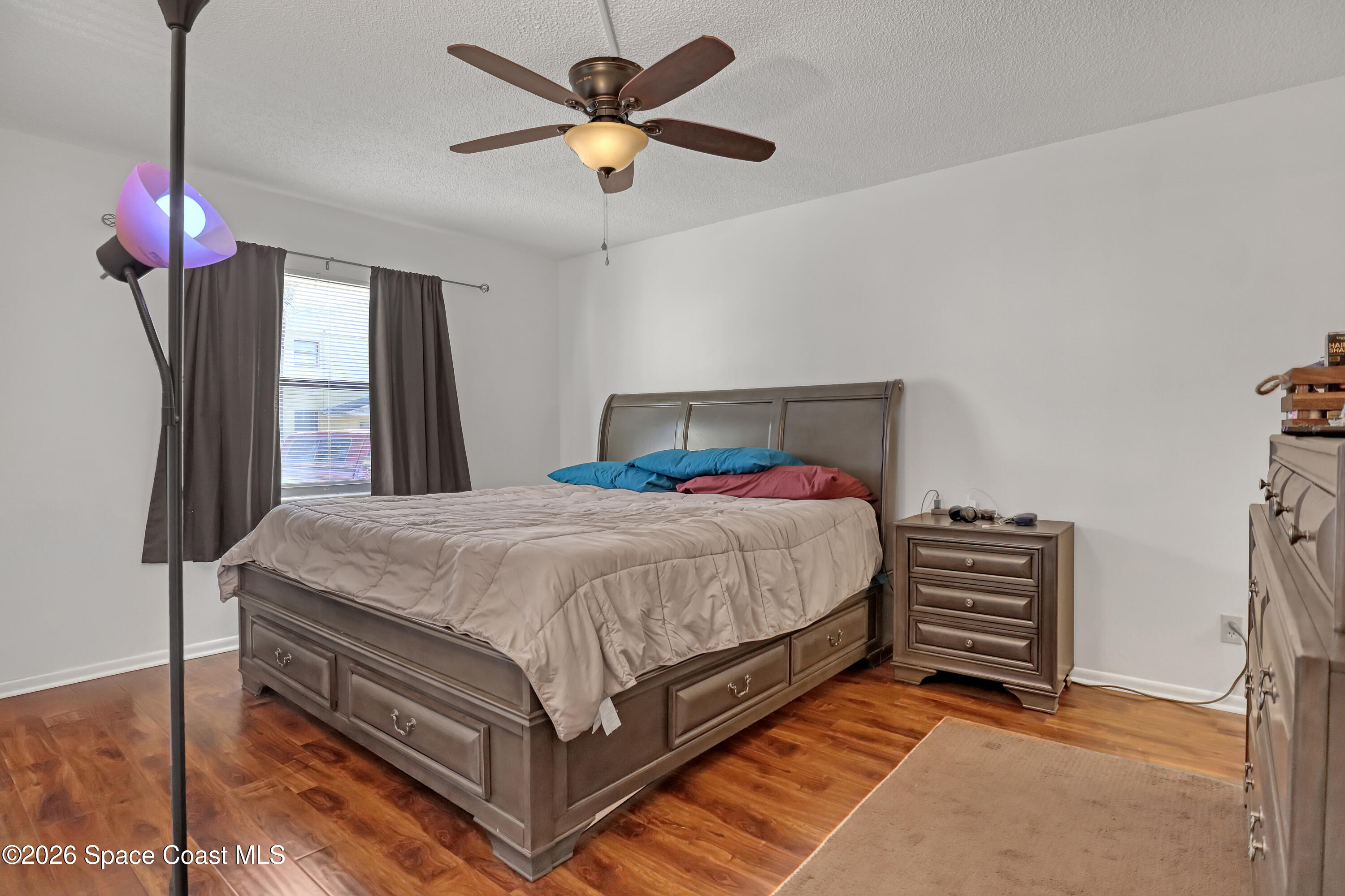588 North Wickham Road, Unit 51 Melbourne, FL 32935 - Photo 13 of 27 a bedroom with a bed chandelier and a closet