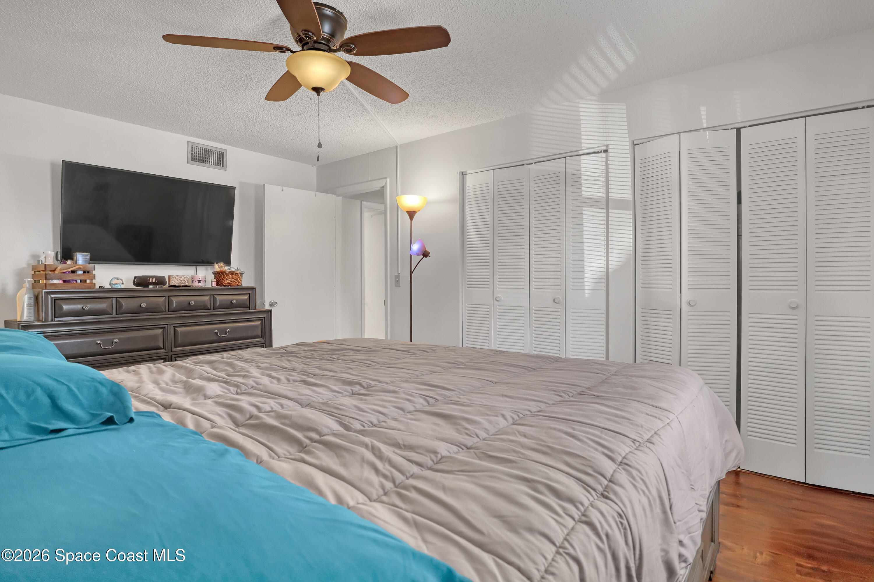 588 North Wickham Road, Unit 51 Melbourne, FL 32935 - Photo 14 of 27 a bedroom with a bed and a flat screen tv